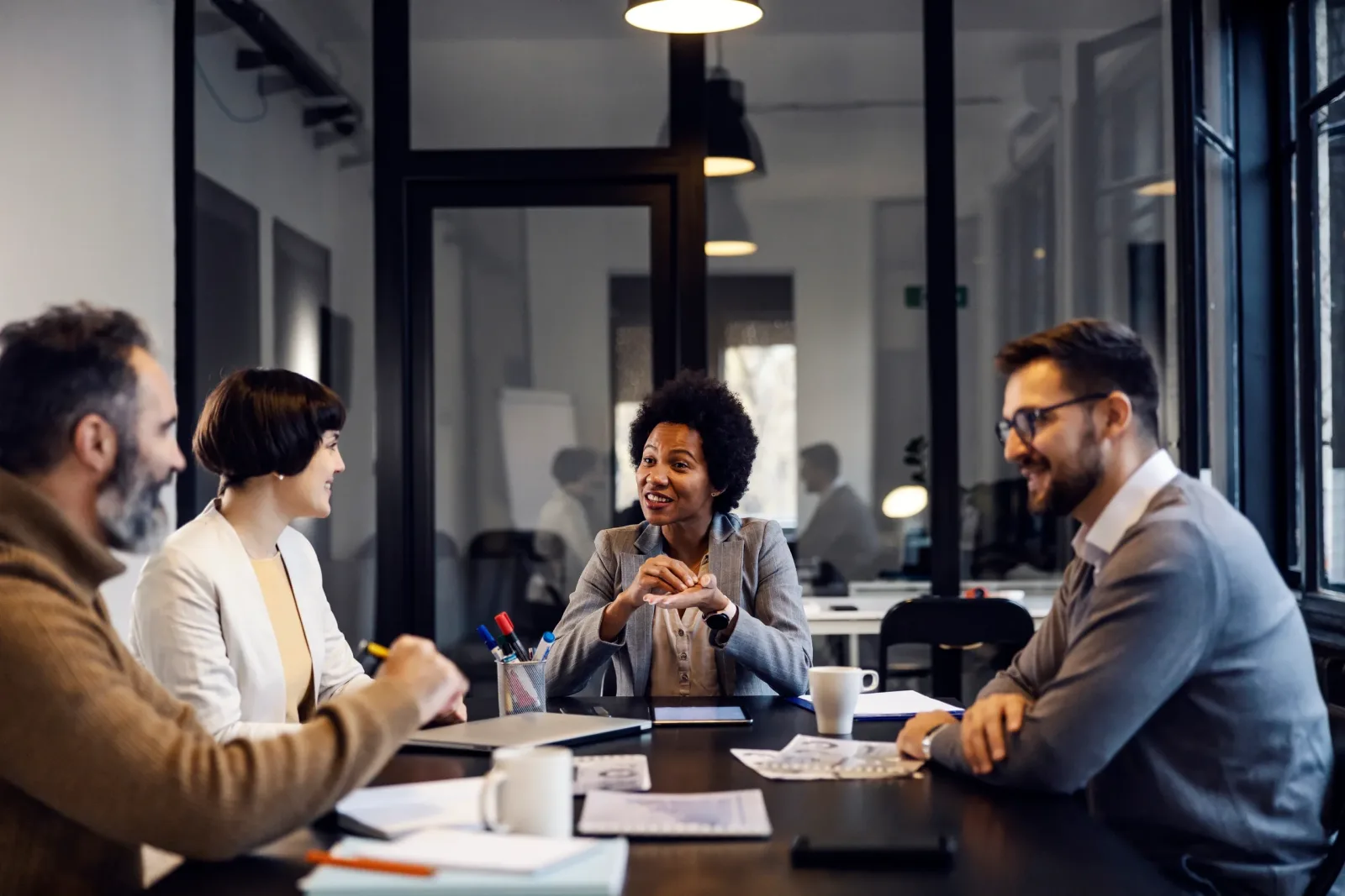 A leadership team in discussion around a conference table
